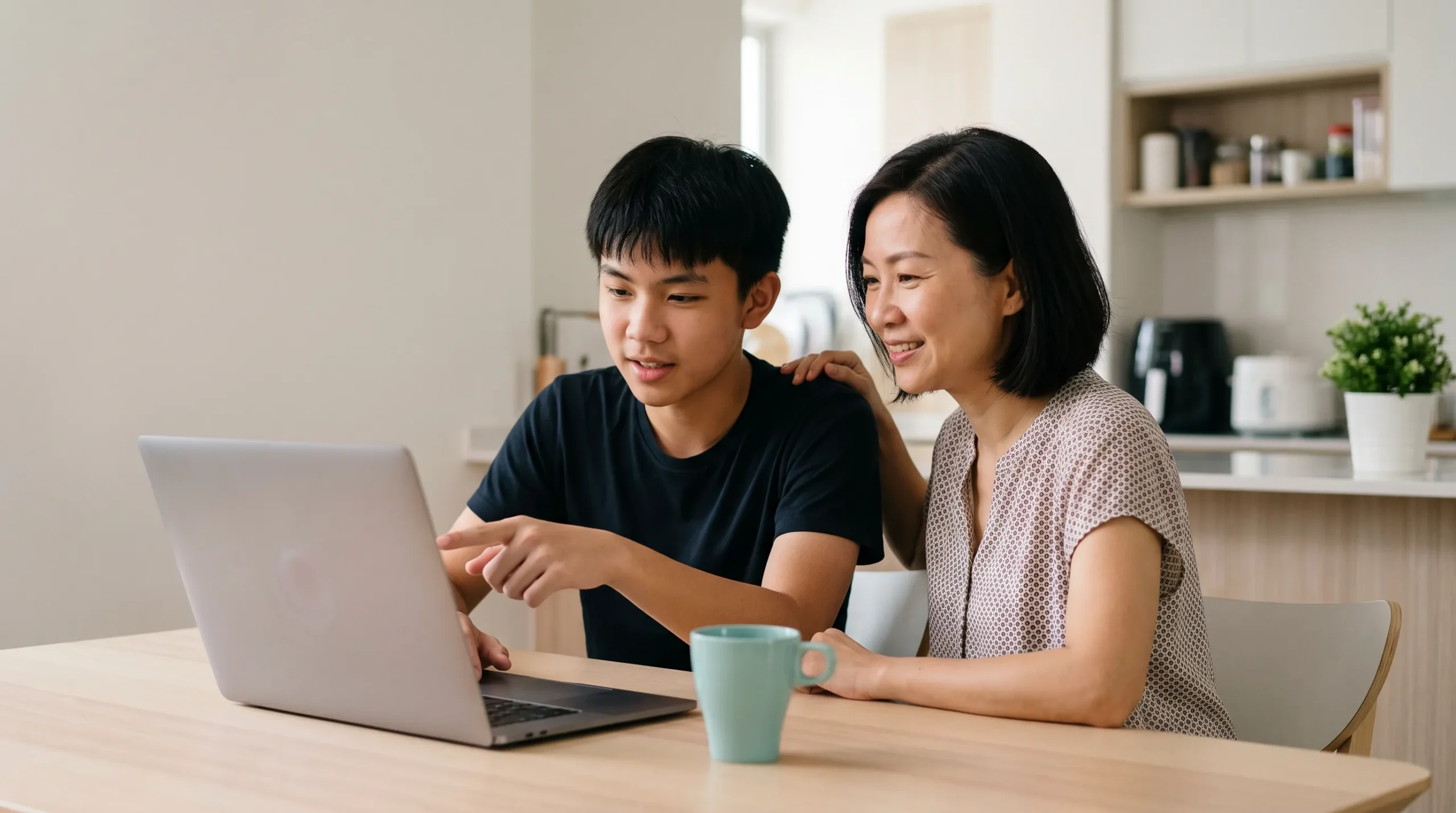 Parent and student checking online tuition progress together on a laptop